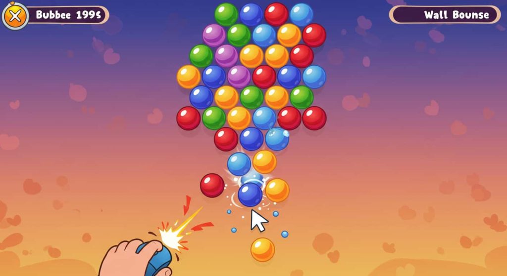 손이 마우스를 잡고 다채로운 버블들을 위로 쏘는 게임 장면. 조준 방향 표시 화살표 있음.